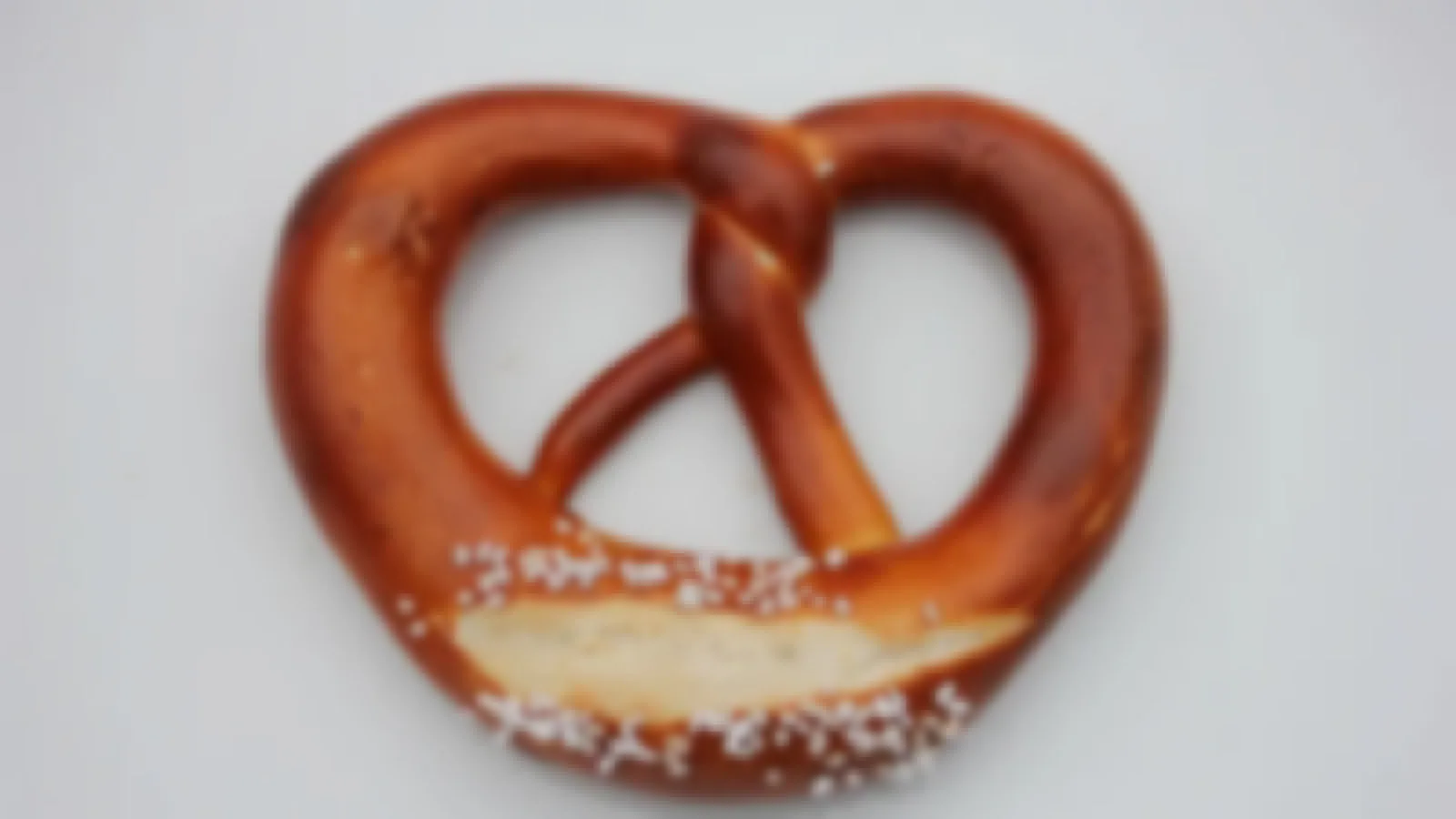 A hand-rolled Laugenbrezel with its dark glossy lye crust and coarse salt
