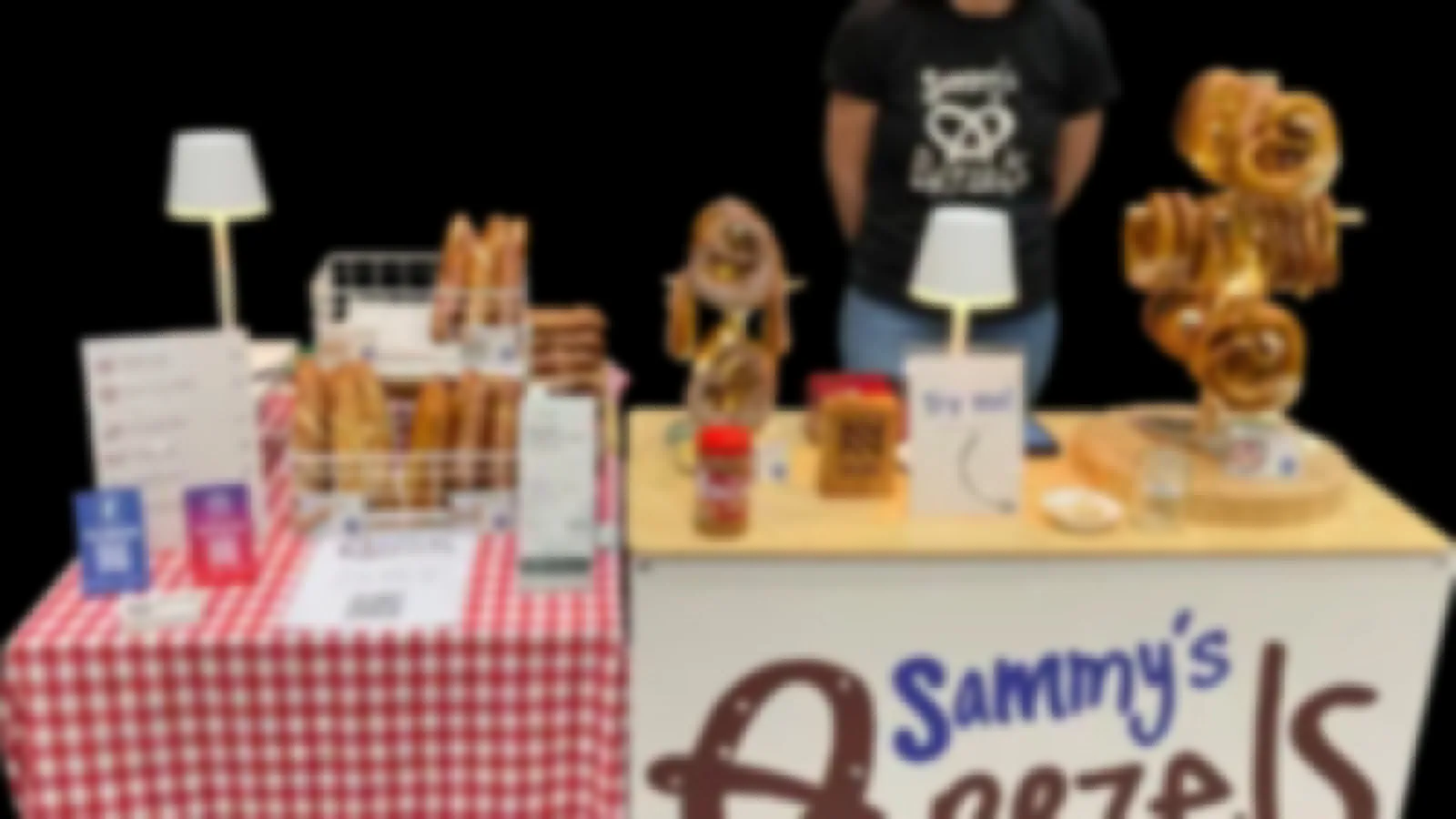 An outdoor market with stalls and shoppers — the markets and events Sammy's Brezels attends